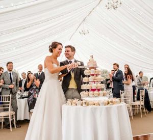 A wedding event with the bride cutting the wedding cake