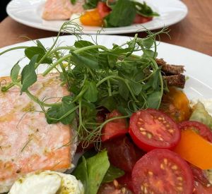 a close shot of a plate with fish and vegetables
